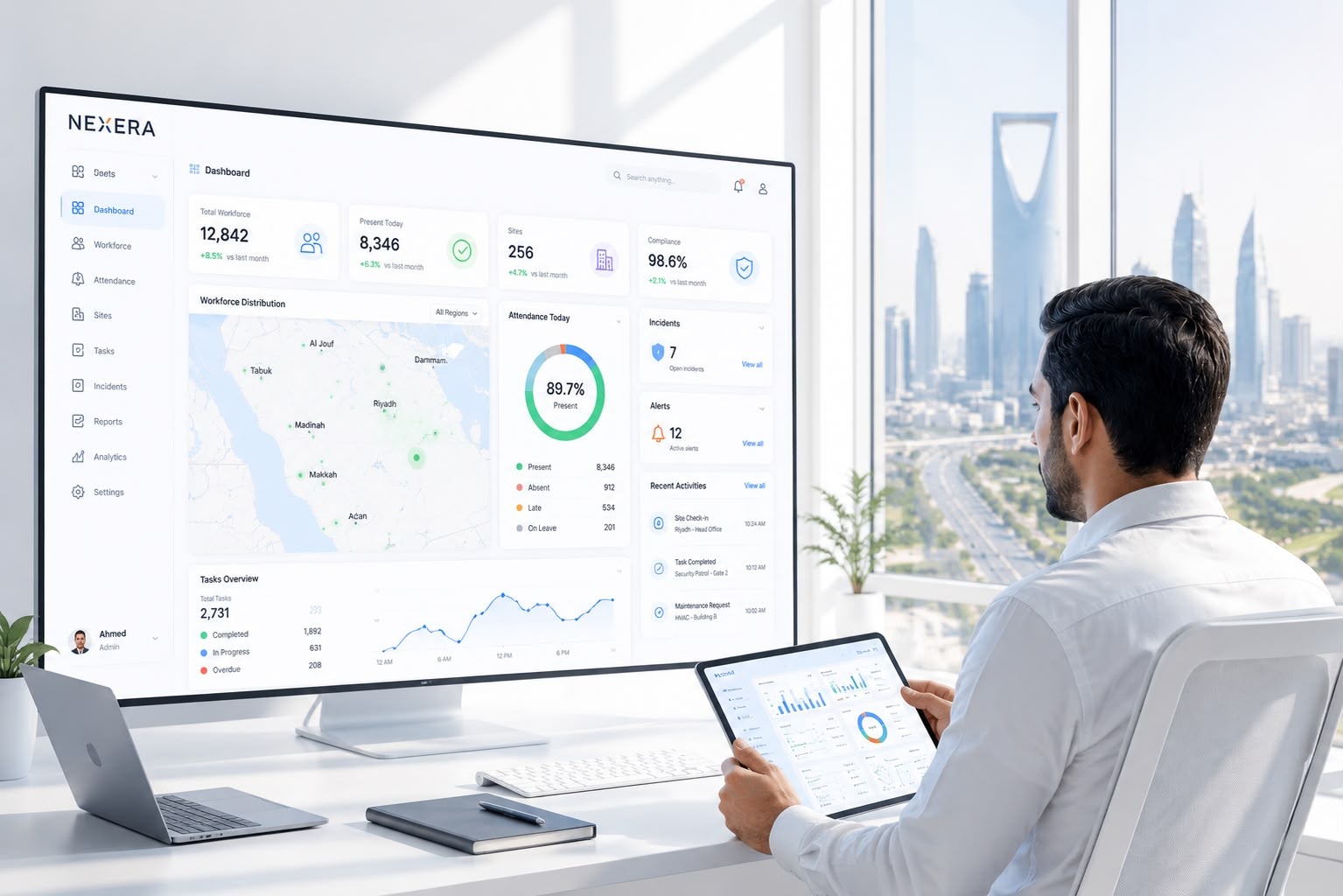 Operations manager reviewing the Nexera workforce dashboard on a tablet and large display in an office overlooking Riyadh.
